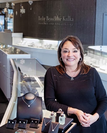 woman sitting by jewelry stand