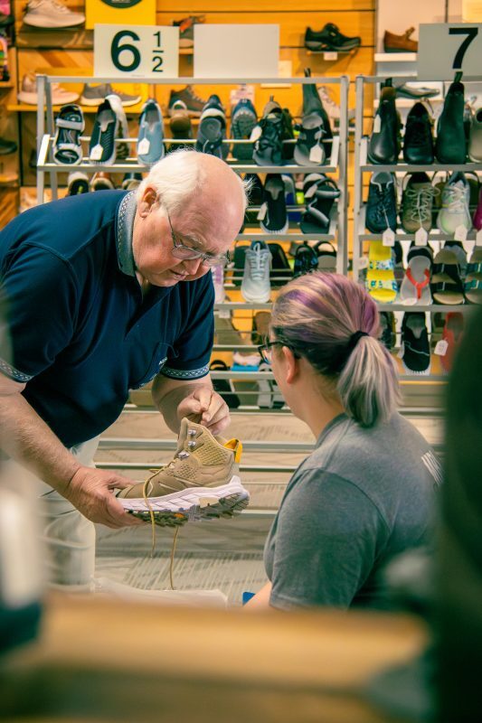 man shows woman a shoe