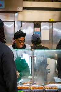 woman behind a deli bar