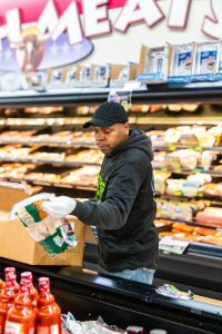 man restocking shelves