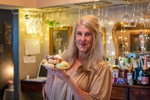 woman holding plate of treats
