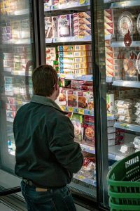man looking at the frozen meals