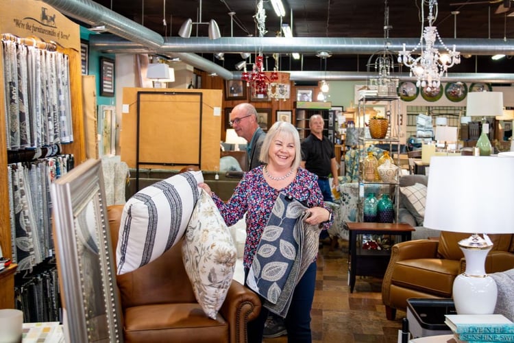 woman holding up pillows and laughing