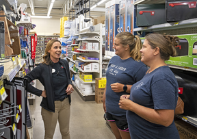 employee helping customers of the hardware store