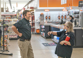 man and woman chatting in store 