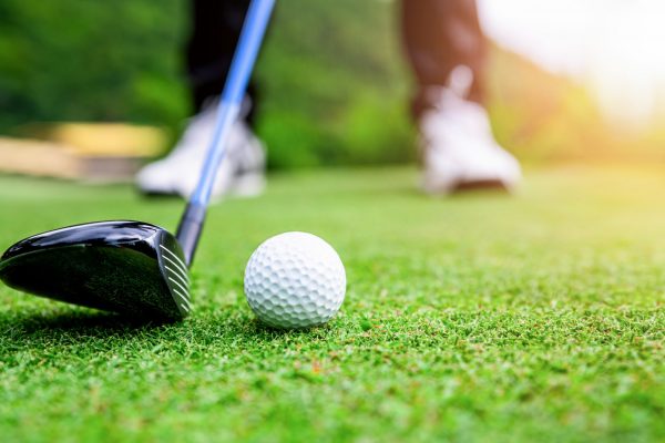 Close up golf ball on green grass field.