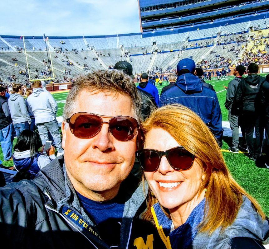 Meredith Gremel and her husband Andy on the field at the University of Michigan's Big House.