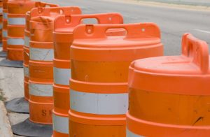 Orange construction barrels along a road.